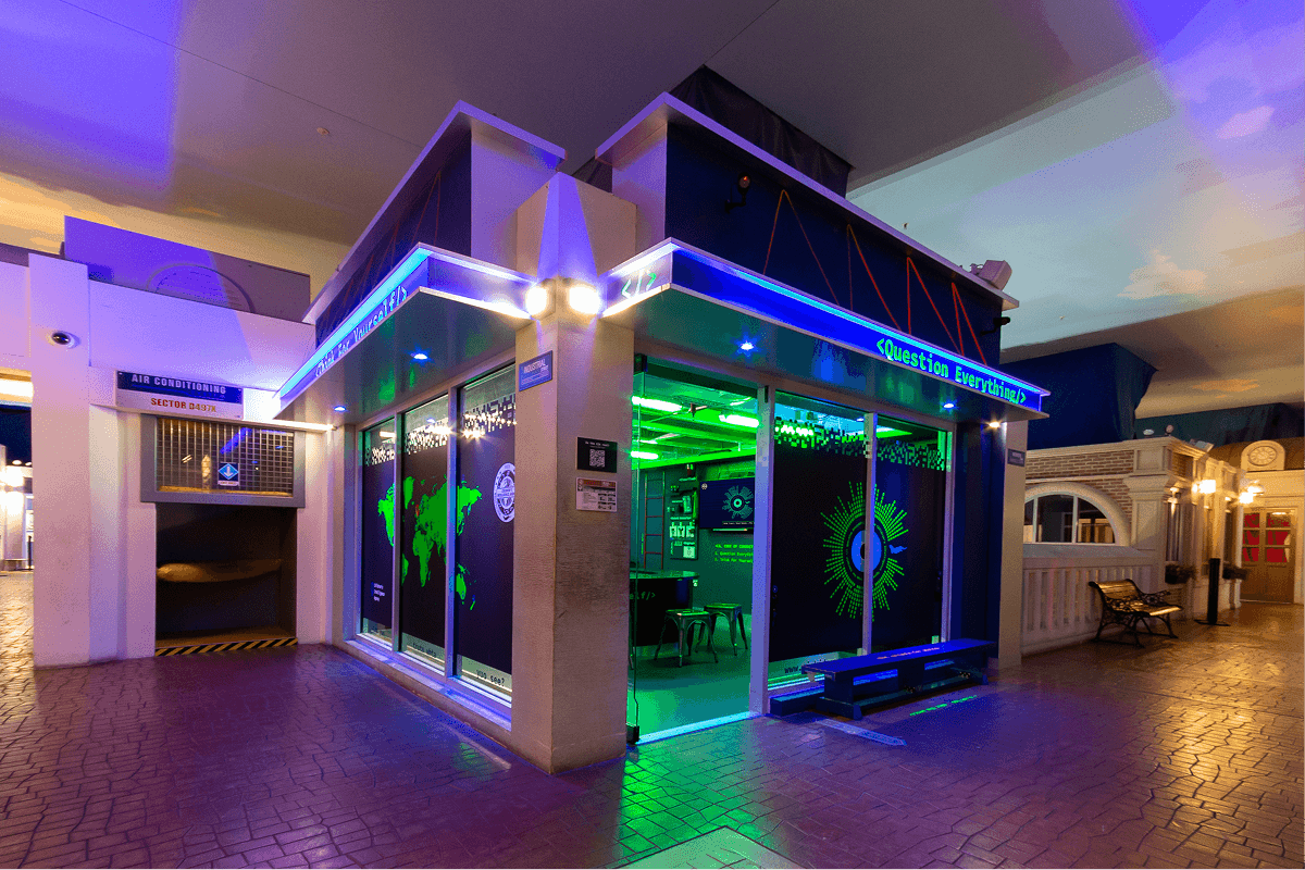 The unit's exterior at a shopping centre, daytime, with the Question Everything signage lit up
