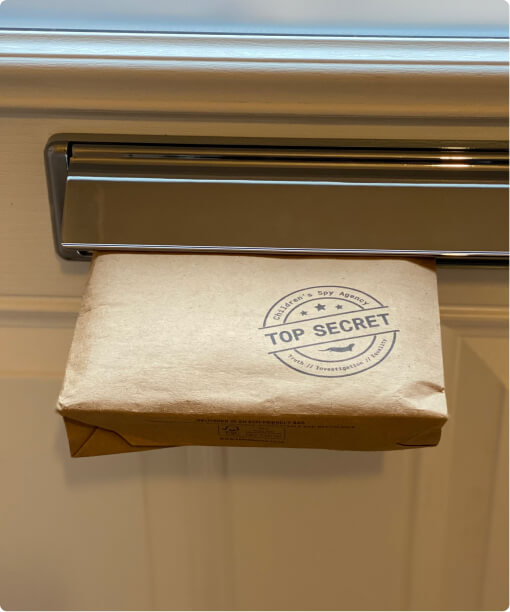 A brown paper package stamped Top Secret, arriving through a letterbox